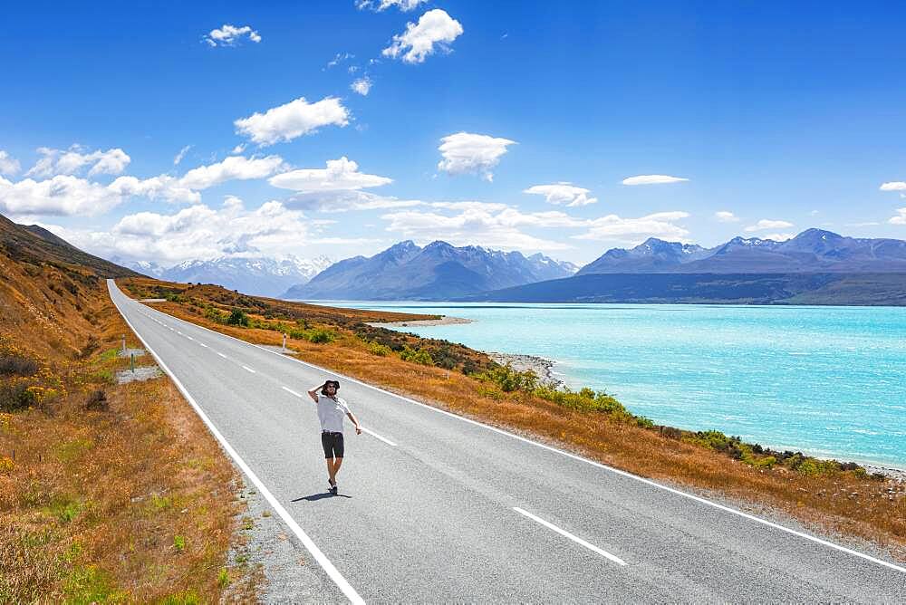 Guy on a road, Lake Pukaki, Mount Cook, Canterbury region, Mackenzie District, South Island, New Zealand, Oceania