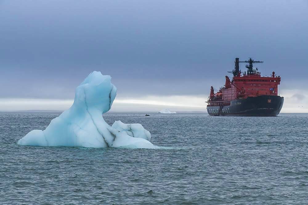 Icebreaker anchoring behind a iceberg, Champ Island, Franz Josef Land archipelago, Russia, Europe