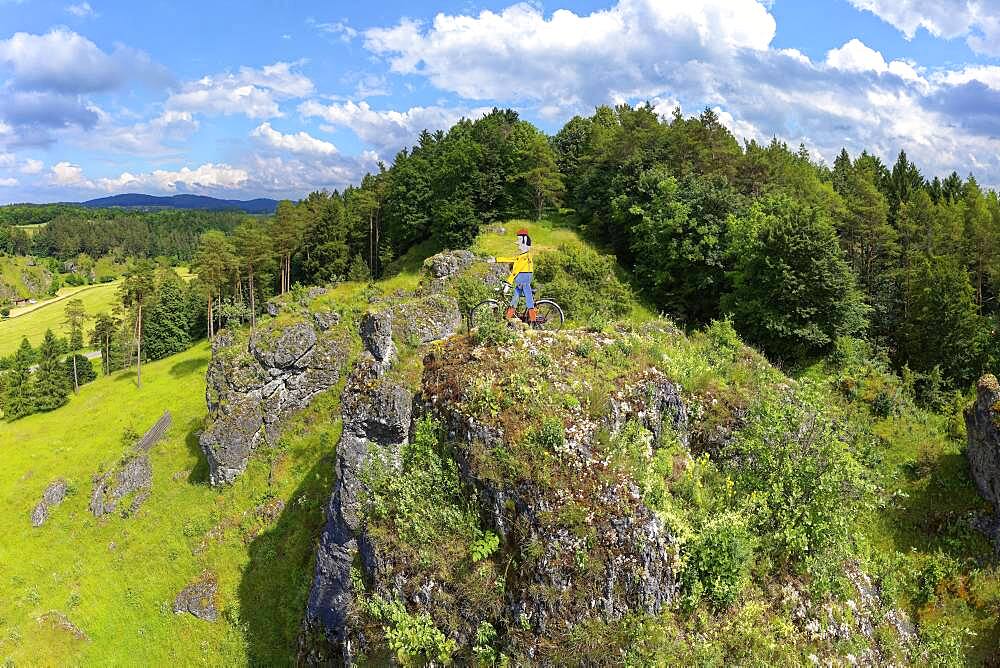 Aerial view of the rock above Oberailsfeld with cyclist figure, called Claudius, Oberailsfeld, Franconian church village, district of Ahorntal, Ailsbachtal, Franconian, Franconian Alb, Upper Franconia, Franconia, Bavaria, Germany, Europe