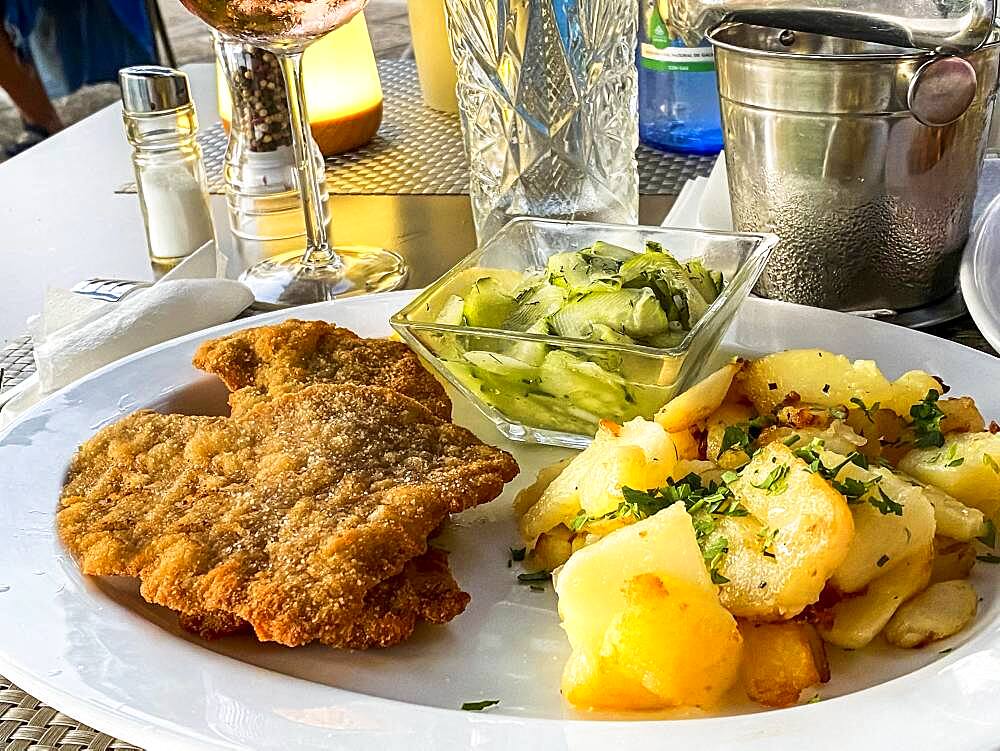 Original Viennese veal escalope with fried potatoes and cucumber salad, Port Andratx, Majorca, Spain, Europe