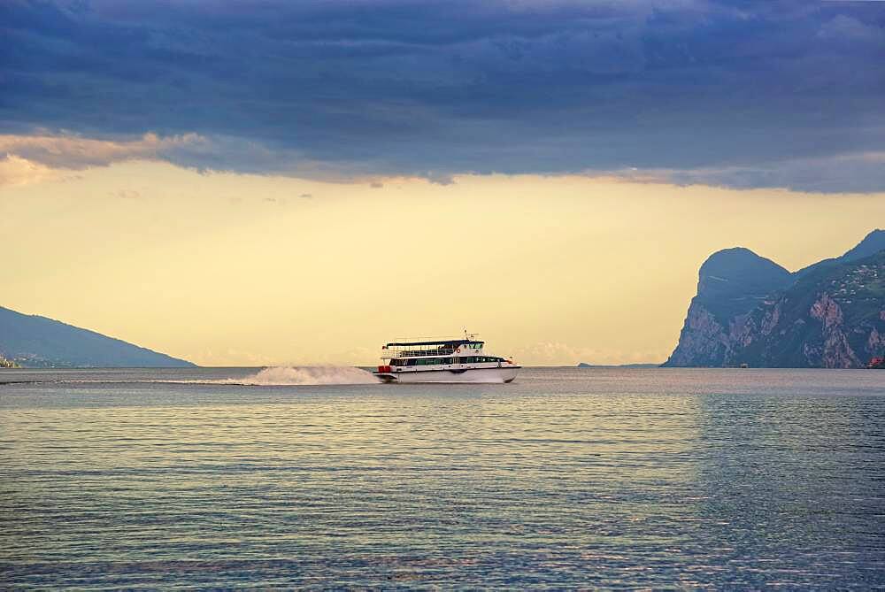 Lake Garda north shore with passenger ferry at sunset, Turbel, Riva de Gardo, Trentino-Alto Adige, Italy, Europe