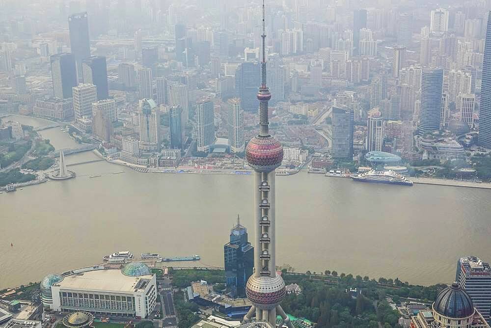 View from the highest observatory of the world on 562 meters height in the 632 meters high skyscraper Shanghai Tower on the special economic zone Pudong with the 468 meters high Oriental Pearl Tower the Huangpu River and the district Tilanqiao, Shanghai, People's Republic of China