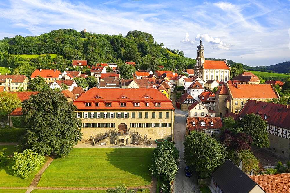 Village centre wine village Castell, castle Castell, early baroque, on the top right county church St. Johannes, behind it vineyard Schlossberg with stair tower old castle, near Wiesentheid, Steigerwald, Lower Franconia, Franconia, Bavaria, Germany, Europe