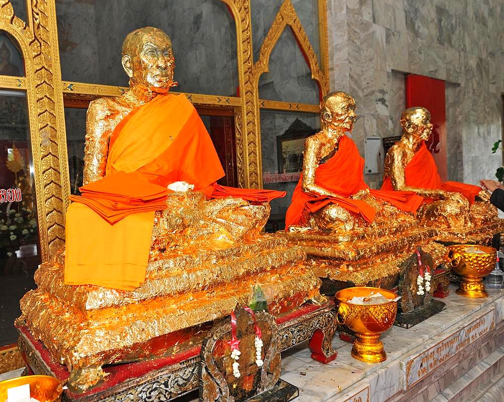 Statues of monks covered with gold leaf in Buddhist temple, Wat Chalong Buddhist monastery, Phuket island, Thailand, Asia