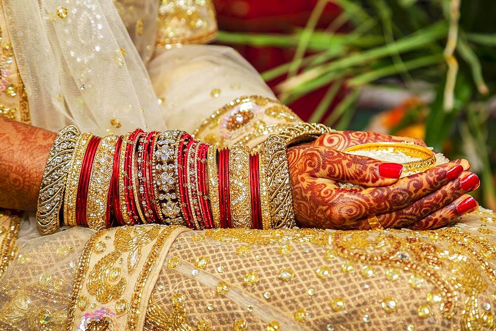 Traditional bridal jewelry and henna decoration on the hands of the bride during a religious ceremony at a Hindu wedding, Mauritius, Africa