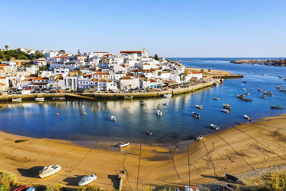 Aerial cityscape of white washed Ferragudo by Arade River, Algarve, Portugal, Europe