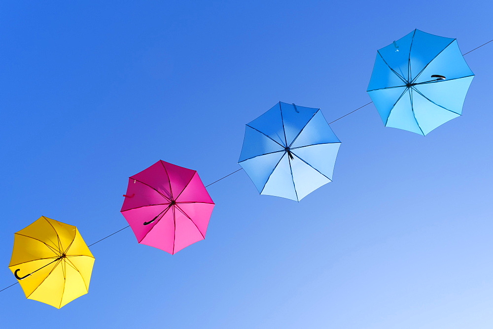 Coloured umbrellas against a blue sky, Gunzenhausen, Altmuehltal, Franconian Lake District, Franconia, Bavaria, Germany, Europe