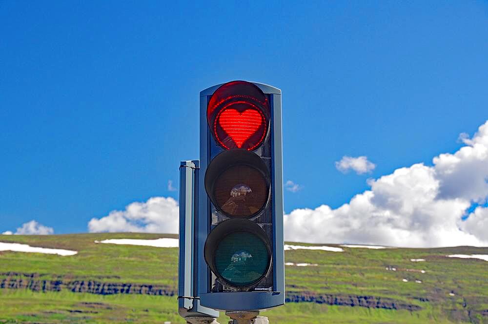 Traffic lights with red heart, mountains in the background, Akureyri, Iceland, Europe