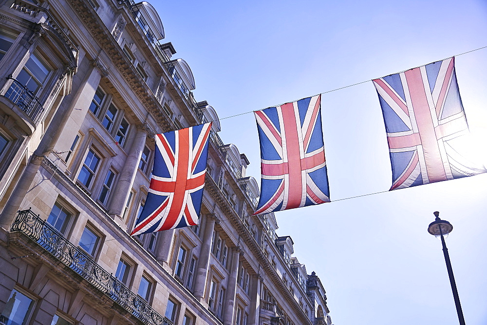 Union Jack flagging over street with old buildings, London, England, United Kingdom, Europe