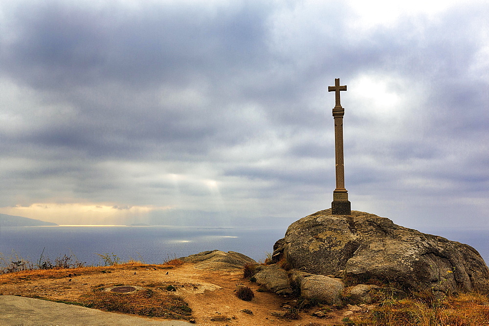 Stone cross on rock, end of the Way of St James at Cape Finisterre, A Coruna Province, Galicia, Spain, Europe