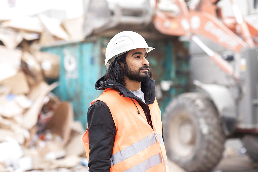 Technician with beard and helmet working in a recycling yard, Freiburg, Baden-Wuerttemberg, Germany, Europe