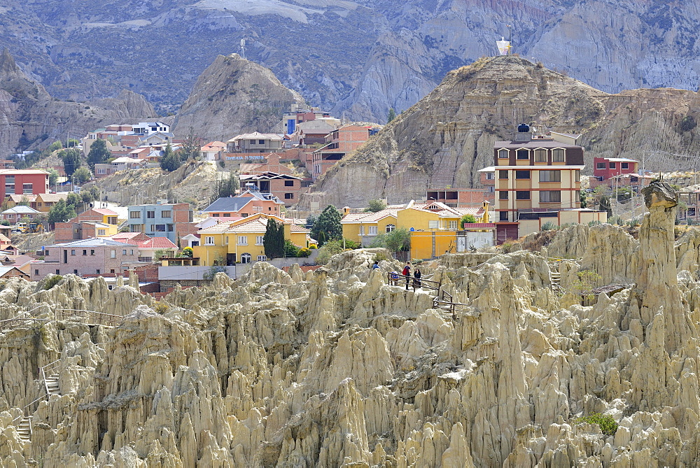 Residential houses behind the bizarre rock formations in Valle de la Luna, La Paz, Bolivia, South America