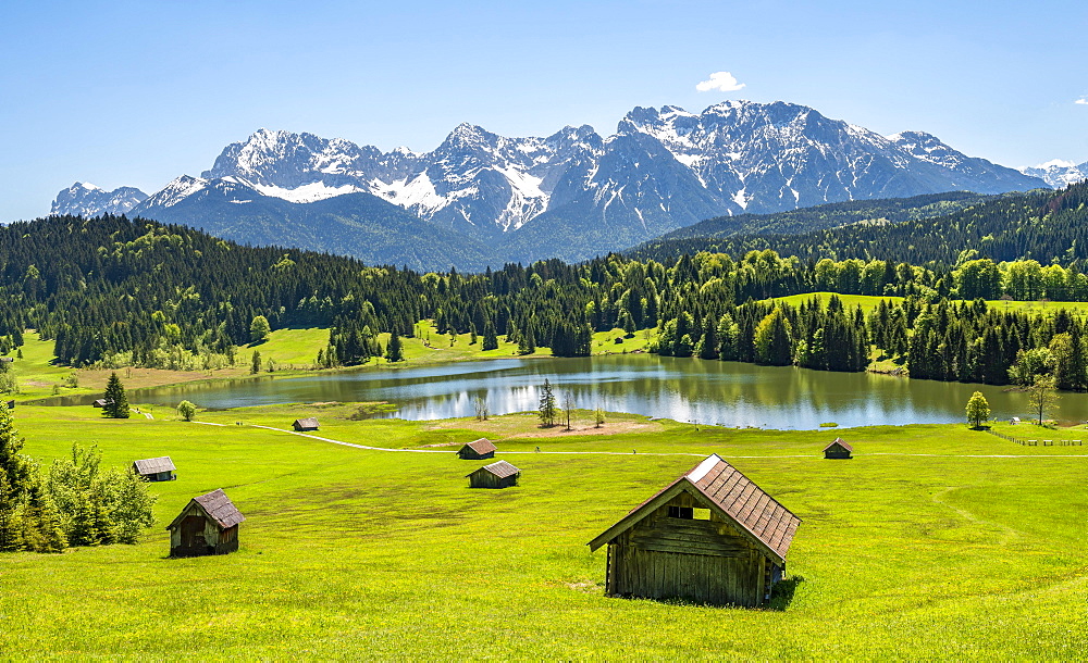 Hay barn in a meadow at Geroldsee, view of Karwendel Mountains in spring, Gerold, Bavaria, Germany, Europe