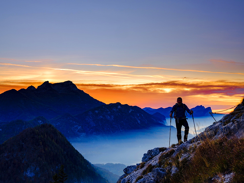 Mountaineers at dusk behind Schafberg and Drachenwand, Salzkammergut, Upper Austria, Austria, Europe