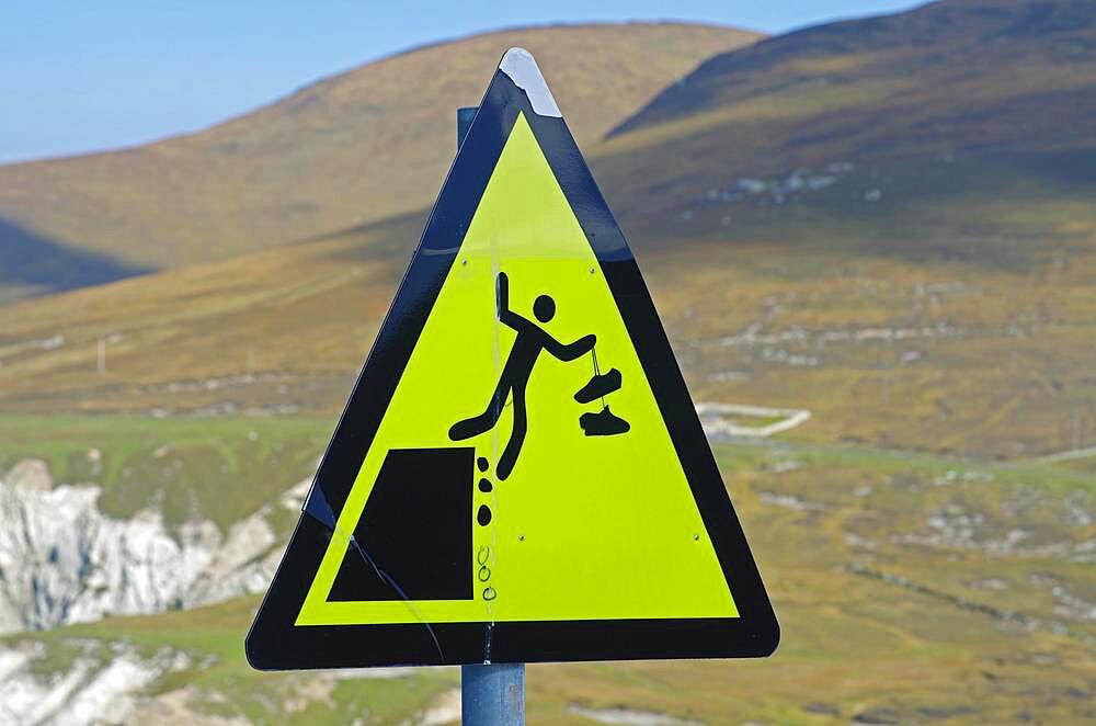 Warning sign with figure falling down, cliffs, Achill Island, Ireland, Europe