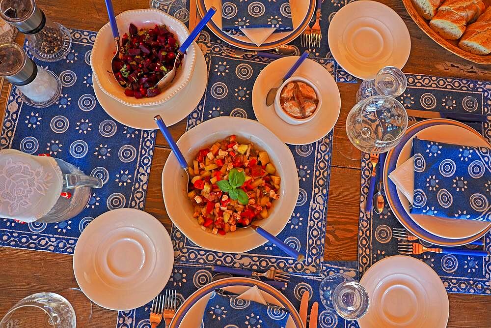 Decorated table with blue and white placemats, napkins and hors d'oeuvres, tapas, beetroot salad, tuna, festively set table, table decoration, table decoration, Spain, Europe