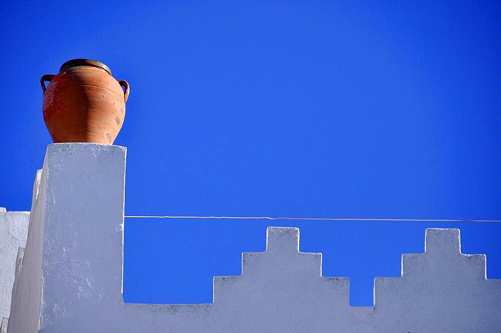 Clay jug on white battlements against a light blue sky, Asilah, northern Morocco, Tangier-Tetouan-Al Hoceima region, Morocco, Africa