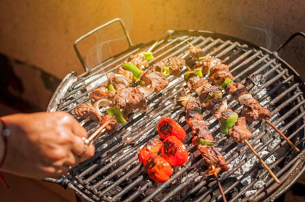 Roast beef skewers on a grill, Roast beef skewers grilling on a grill