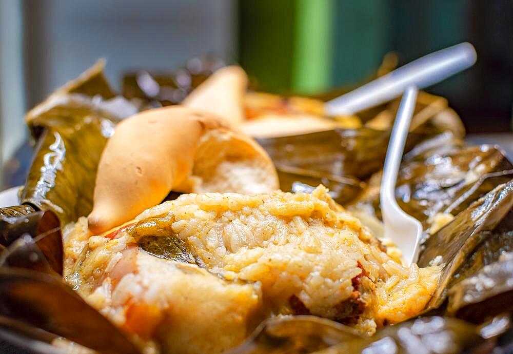 Nacatamal served in banana leaf, Close up of Nicaraguan nacatamal, Typical Nicaraguan food El nacatamal, Typical Nicaraguan food