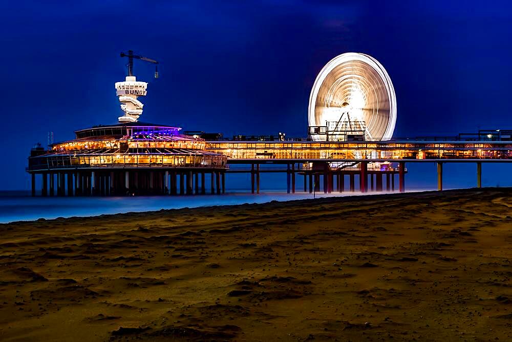 Scheveningse Pier on the beach of Scheveningen, a modern seaside resort grown together with The Hague on the Dutch North Sea coast, long exposure, blue hour, province of South-Holland, Zuid-Holland, Netherlands