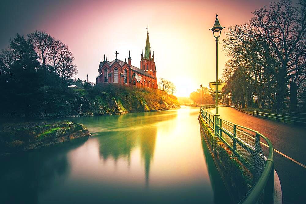 Trollhaettan, neo-Gothic church by the waterworks in the middle of the river, sunset, southern Sweden, Sweden, Europe