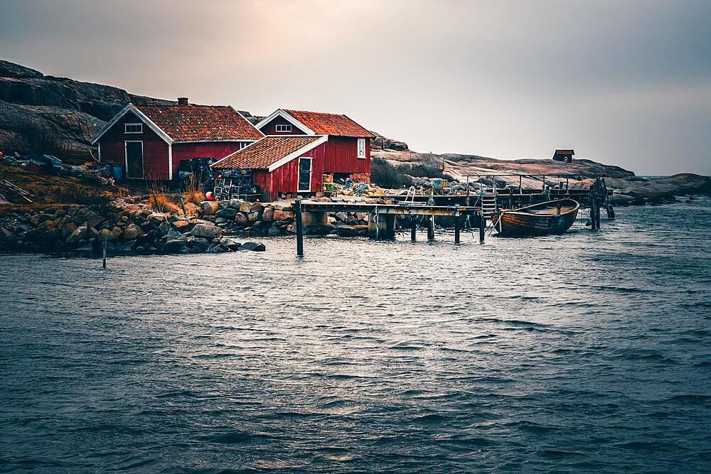 Swedish house, with jetty and boat by the sea, Tjurpannans Nature Preserve, Sweden, Scandinavia, Europe