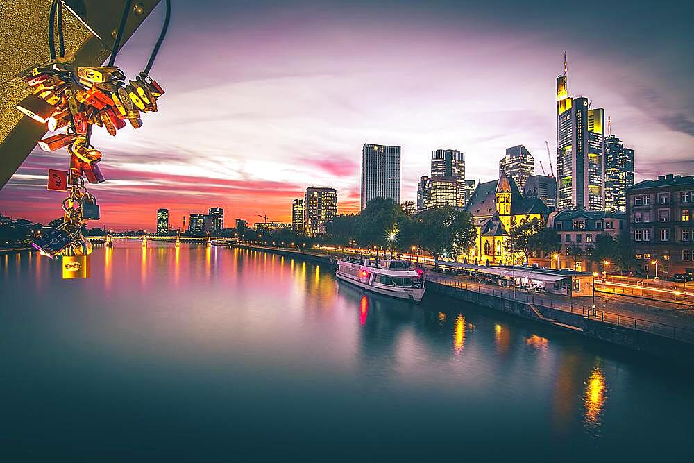 View over the river Main to the sunset skyline of Frankfurt am Main, evening, love castles, backlit sunset, Hesse, Germany, Europe