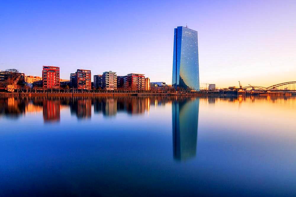 European Central Bank ECB, in front of it the summer shipyard and flats, sunrise and reflection on the banks of the Main, Frankfurt am Main, Hesse, Germany, Europe