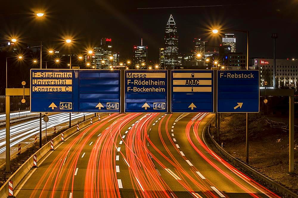 Motorway at night, long exposure with skyline, signs and light trails, Frankfurt am Main, Hesse, Germany, Europe