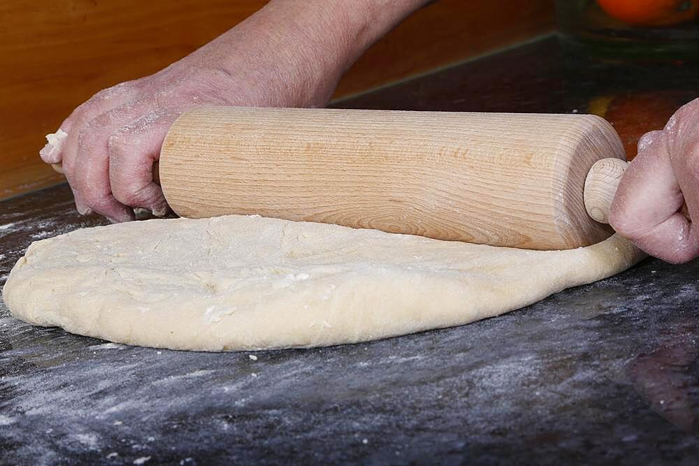 Swabian cuisine, baking, preparing yeast yeast dough, rolling out dough, rolling pin, dough roller, men's hands, Germany, Europe