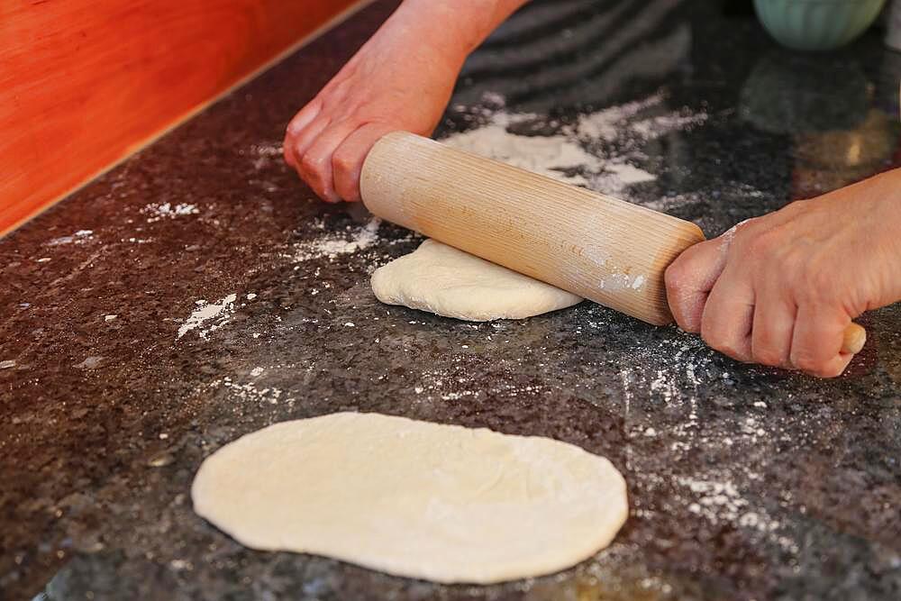 Swabian cuisine, preparation Hohenloher Blootz, Blooz, salty yeast pastry, rolling pin, men's hands, Germany, Europe