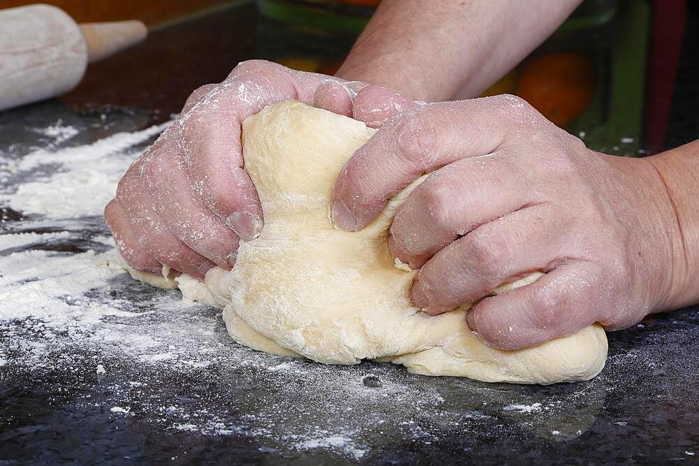 Swabian cuisine, baking, preparing yeast yeast dough, kneading dough, flour, men's hands, Germany, Europe