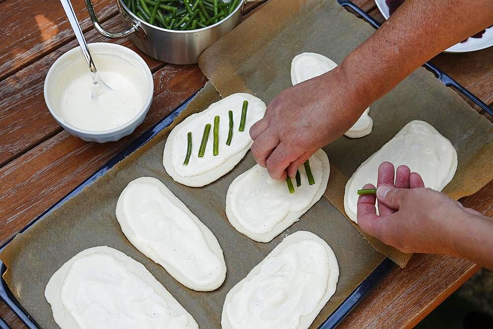 Swabian cuisine, preparation Hohenloher Blootz, Blooz, salty yeast pastry, sour cream, green beans, men's hands, Germany, Europe