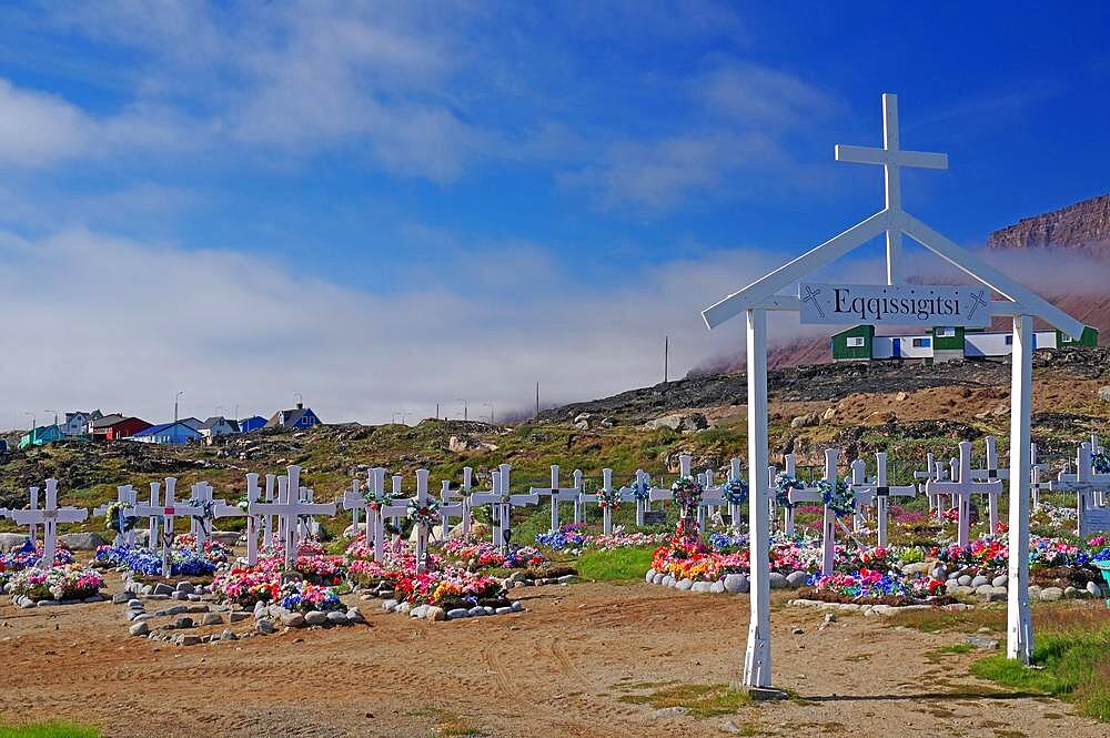 Wooden crosses in front of graves decorated with colourful artificial flowers, Disko Island, Qeqertarsuaq, Arctic, Greenland, Denmark, North America