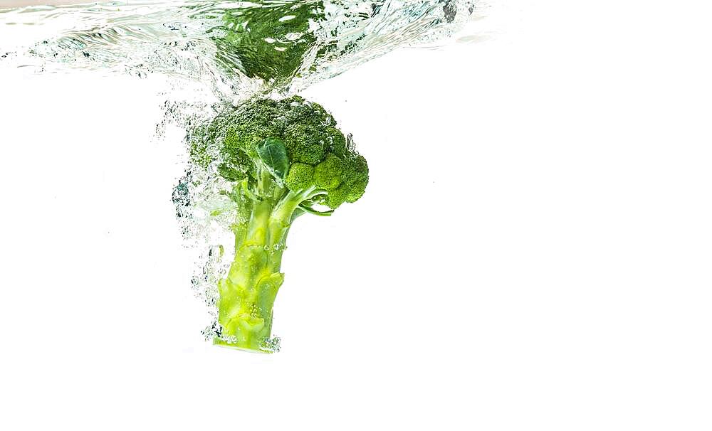 Close-up of broccoli splash into water isolated on white, Healthy food concept