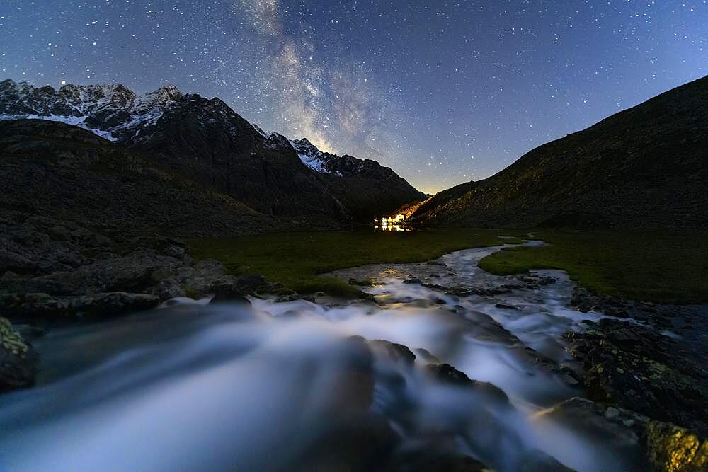 Mountain stream with Winnebachsee hut and Winnebach peaks with starry sky and Milky Way, Sellrain, Innsbruck, Tyrol, Austria, Europe