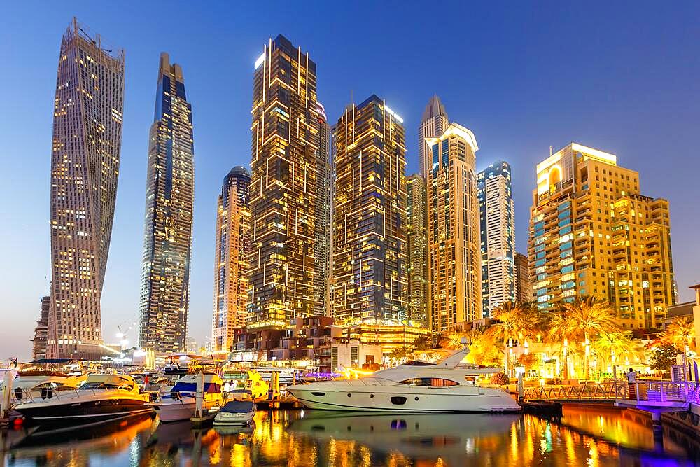 Dubai Marina and Harbour Skyline Architecture Luxury Holiday in Arabia with Boat Yacht by Night in Dubai, United Arab Emirates, Asia