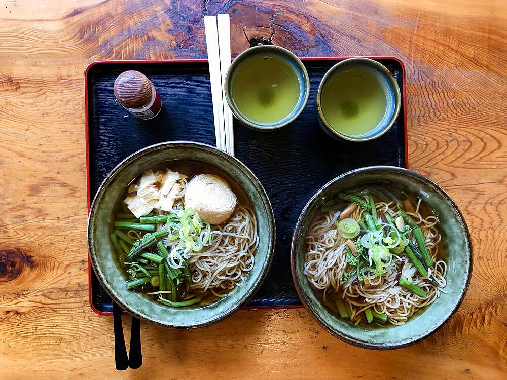 Tray with two portions of traditional Japanese noodle soup and green tea, ramen with wild vegetables, Nikko, Japan, Asia