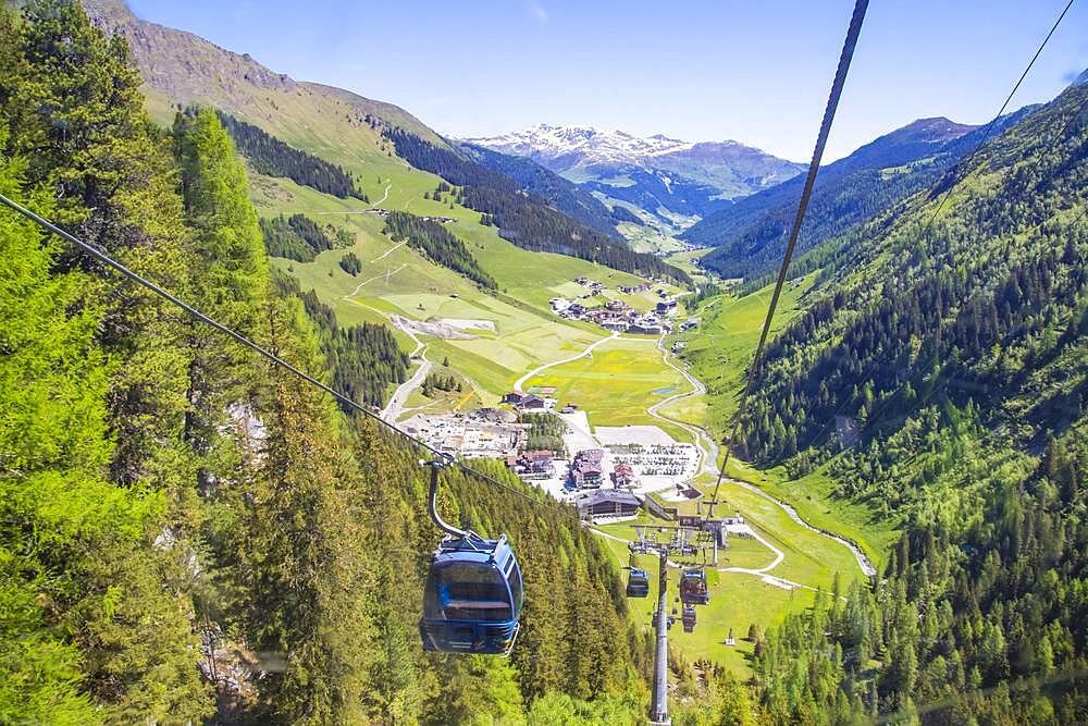 Mountain railway glacier bus above the valley station of the Hintertux glacier, in the back the village of Hitnertux, Tuxertal, Tyrol