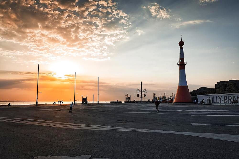 Willy-Brandt-Platz with lighthouse Unterfeuer at sunset, back light, seaside resort quay, Havenwelten, Bremerhaven, Bremen, Germany, Europe