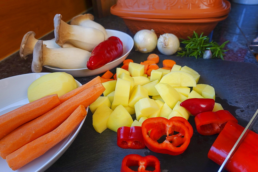 Southern German cuisine, preparing vegetables from the Roman pot, cutting vegetables, red peppers, carrots, diced potatoes, mushrooms, herb mushrooms, onions, knife, chopping board, rosemary, Germany, Europe