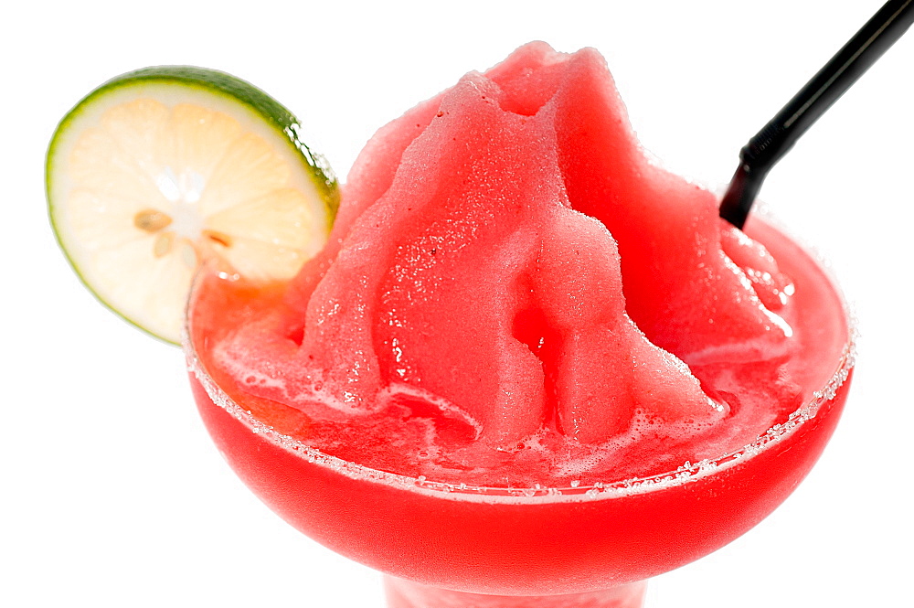 Frozen strawberry margarita daiquiri with lime and black straw isolated on white background