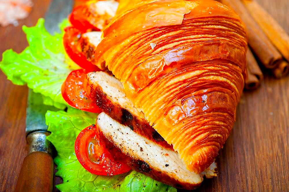 Savory croissant brioche bread with chicken breast and vegetable rustic style