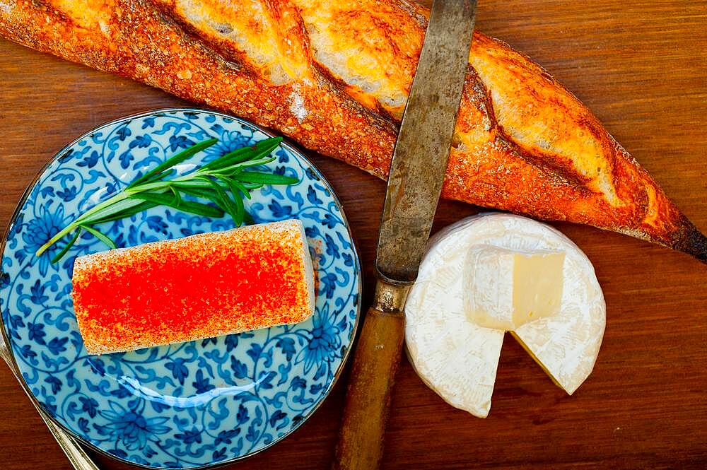 French cheese and fresh baguette on a wood cutter