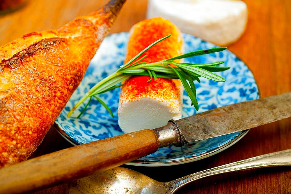 French cheese and fresh baguette on a wood cutter