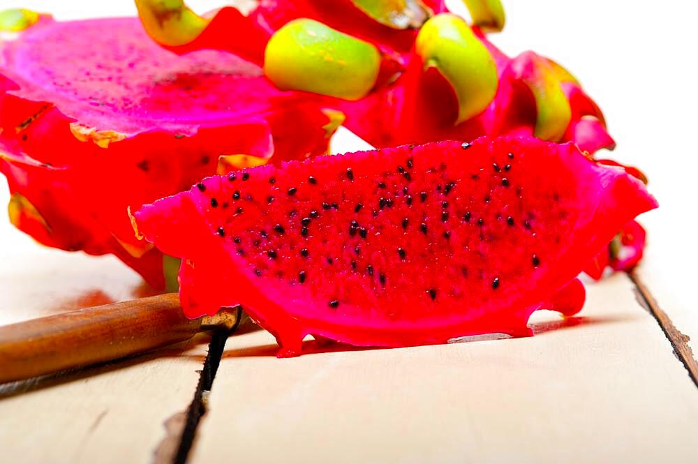 Fresh thai purple dragon fruit over white rustic table