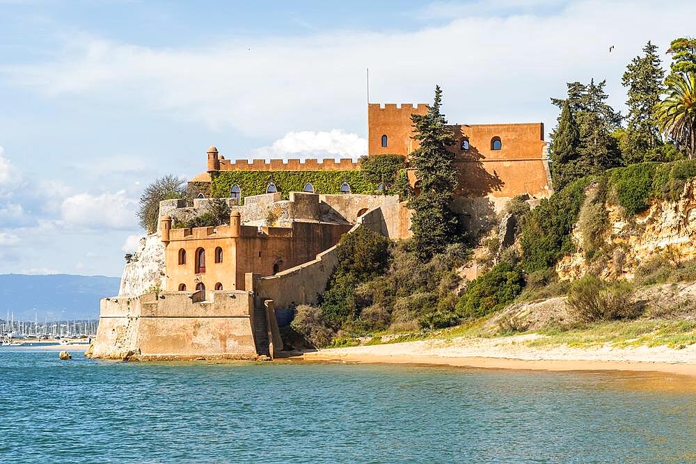 Coastline with sandy beach and Sao Joao castle in Ferragudo, Algarve, Portugal, Europe