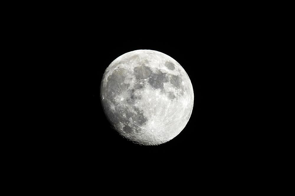 Almost full moon against A black sky shot from southern California, USA, North America