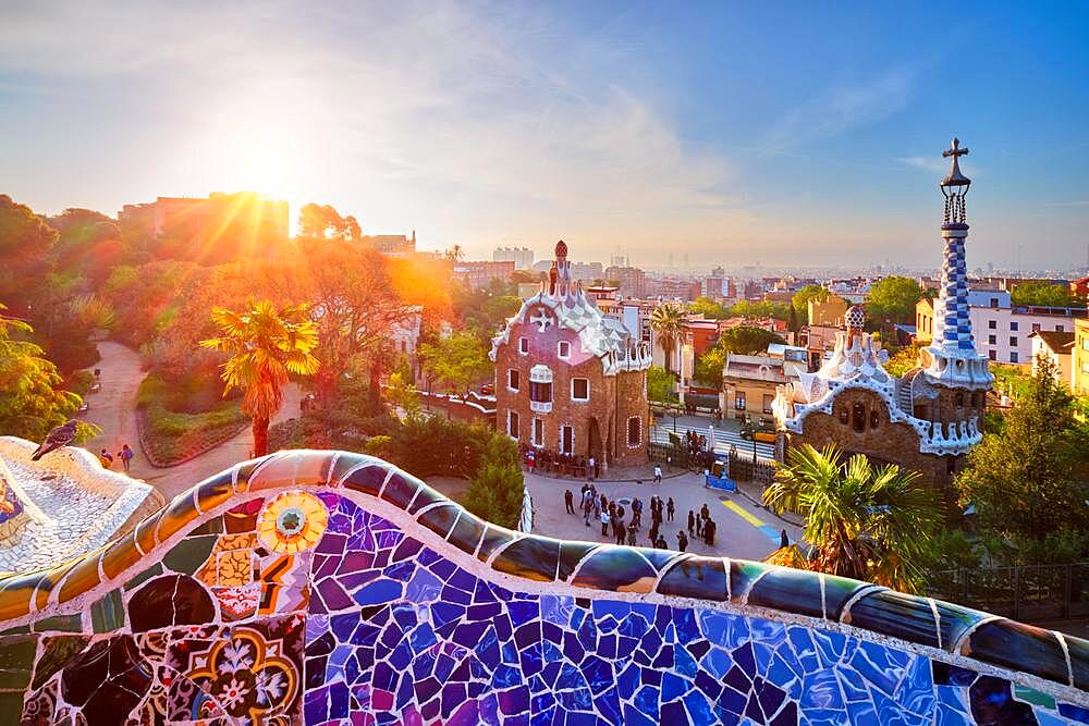 Barcelona city view from Guell Park with colorful mosaic buildings in tourist attraction Park Guell in the morning on sunrise, Barcelona, Spain, Europe