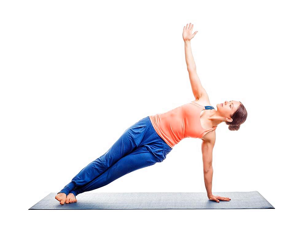 Beautiful sporty fit woman practices yoga asana Vasisthasana, side plank pose isolated on white